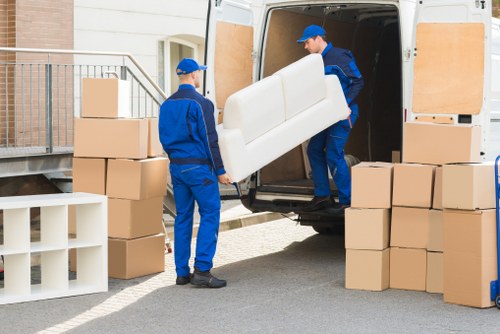 Moving team handling boxes and furniture for an Ilford property