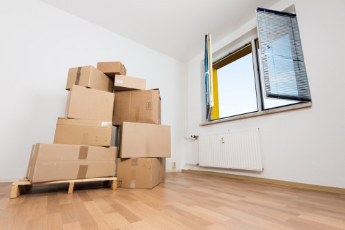 Local furniture removal team transporting a sofa in Ilford