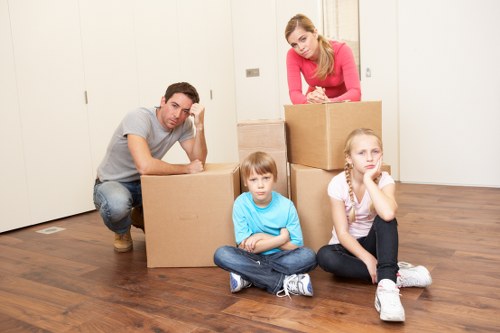 Professional movers carrying furniture during same day relocation